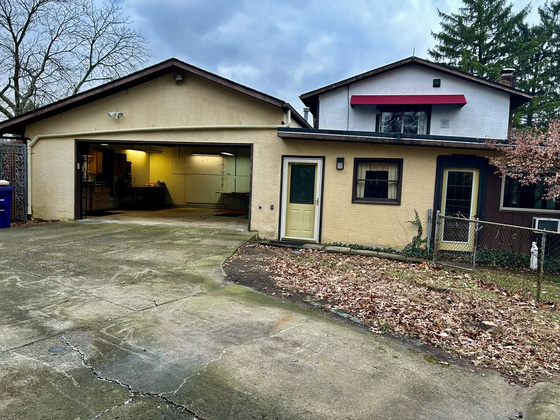 Side Load 2-1/2 Car, Heated, Attached Garage, Work Bench , Shop Area.